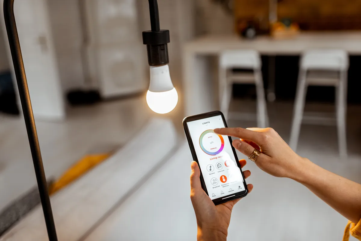 A person using a phone app to control their smart lights in their home.
